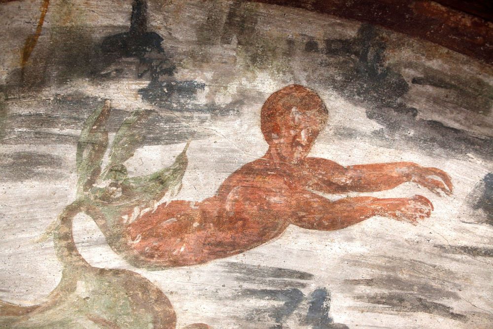 Jonah, the Old Testament prophet, is spit out of the whale in this fresco seen during the unveiling of two newly restored burial chambers in the Christian catacombs of St. Domitilla in Rome May 30, 2017. (CNS/Carol Glatz)