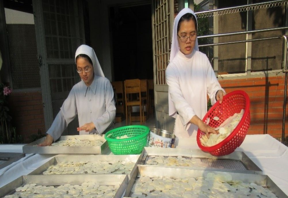 Sisters make Communion wafers.