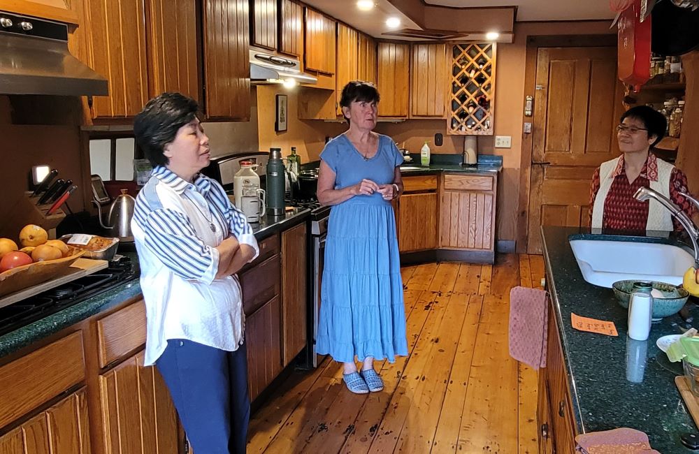 Members of the Sisters of the Earth Community gather in the kitchen at Green Mountain Monastery. 