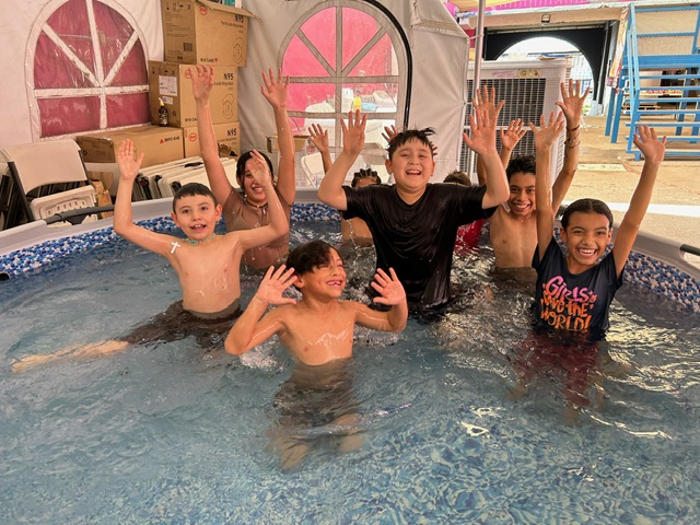 Children cool off in a plastic pool donated by California nonprofit Border Compassion to the Cobina Posada del Migrante shelter in Mexicali, Mexico, where temperatures reached 120 degrees July 8. The nonprofit, founded by Sr. Suzanne Jabro, organized a hot weather fund to purchase plastic pools, popsicles, fruit and transportation to cooler venues for those at the shelter, which has no air conditioning, as temperatures hovered in the 110s this summer. (Courtesy of Border Compassion)