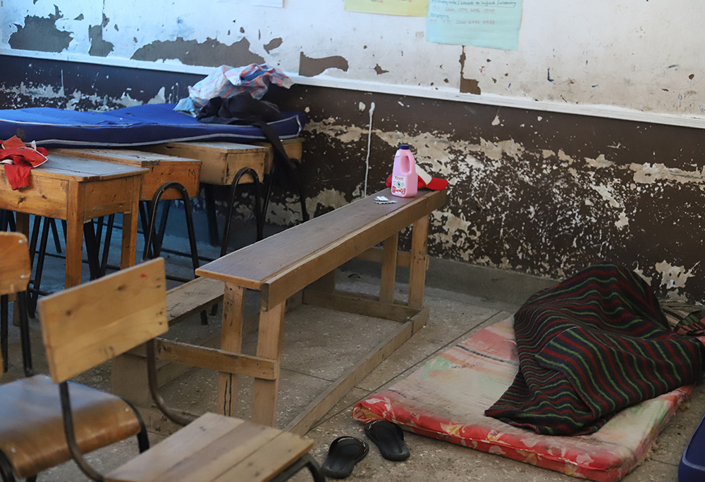 A homeless person sleeps in a classroom of a local school after his house was swamped with water due to floods in Nairobi, on April 17. (GSR photo/Doreen Ajiambo)