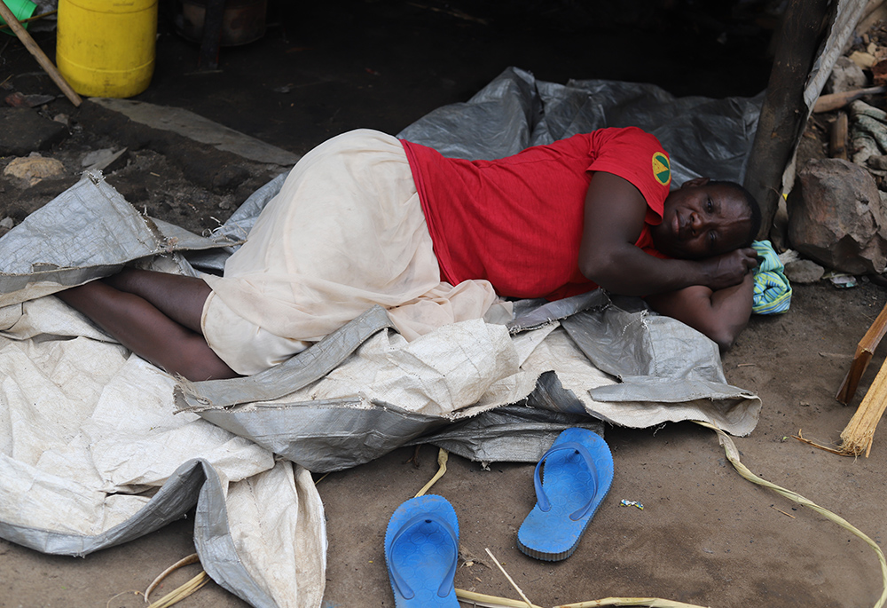 A woman sleeps outside her tent in Khumwanda displacement camp in Busia on July 16, after floods swamped her house. (GSR photo/Doreen Ajiambo)