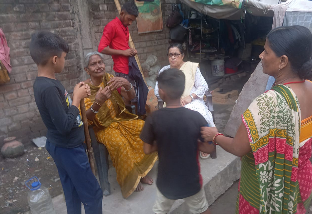 Sr. Dorothy Fernandes visits an older woman who lives on the pavement in the Gayatri Mandir area on Aug. 1. (Sudarshan Kumar)