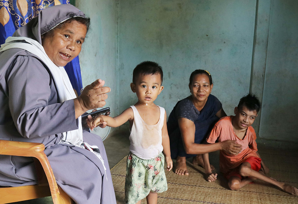 Sr. Elis Lamin, a member of the Visitation Sisters of Don Bosco, talks to a child during a family visit in Nunchhara Punjee in Sylhet Diocese, in northeast Bangladesh. (GSR photo/Stephan Uttom Rozario)