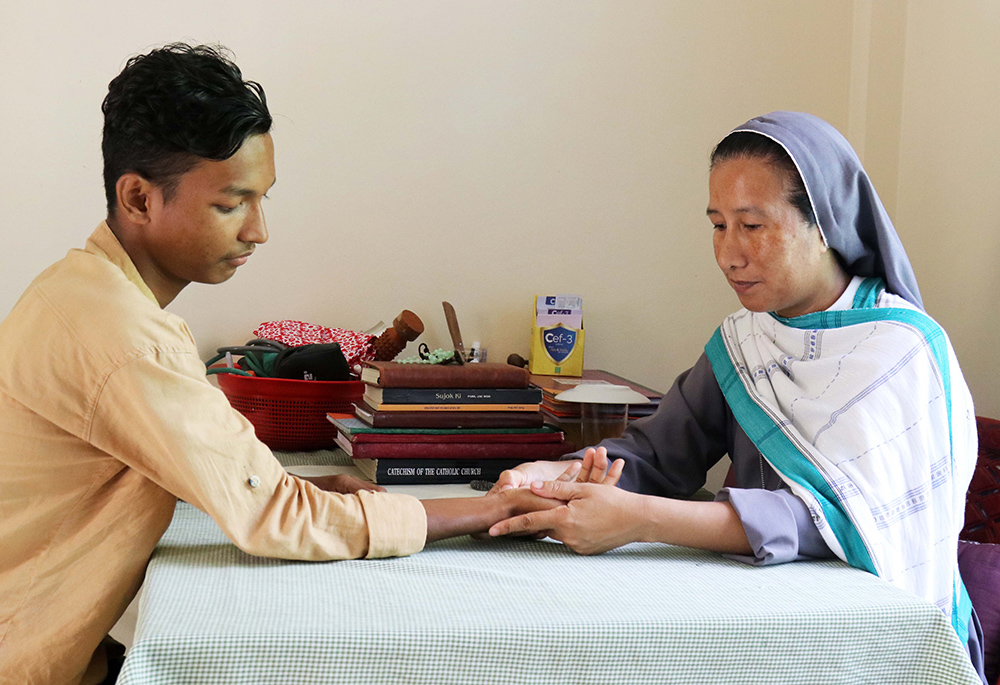 Sr. Mary Lyneda Lyndem provides acupressure therapy to a villager. (GSR photo/Stephan Uttom Rozario)