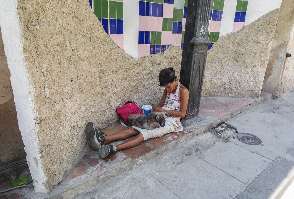 A local homeless person sits just a few meters from Casa Santa Brigida in Havana. (Joanna Kozakiewicz)