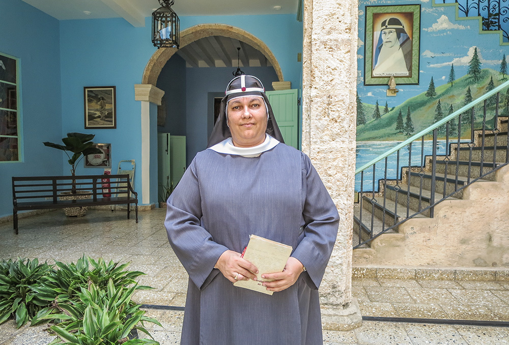 Sr. María Ángel Díaz Ledesma in the hallway of Casa Santa Brigida in Havana. Behind her is a portrait of the founder of the Order of the Most Holy Savior of St. Bridget, St. Mary Elizabeth Hesselblad. (Joanna Kozakiewicz)