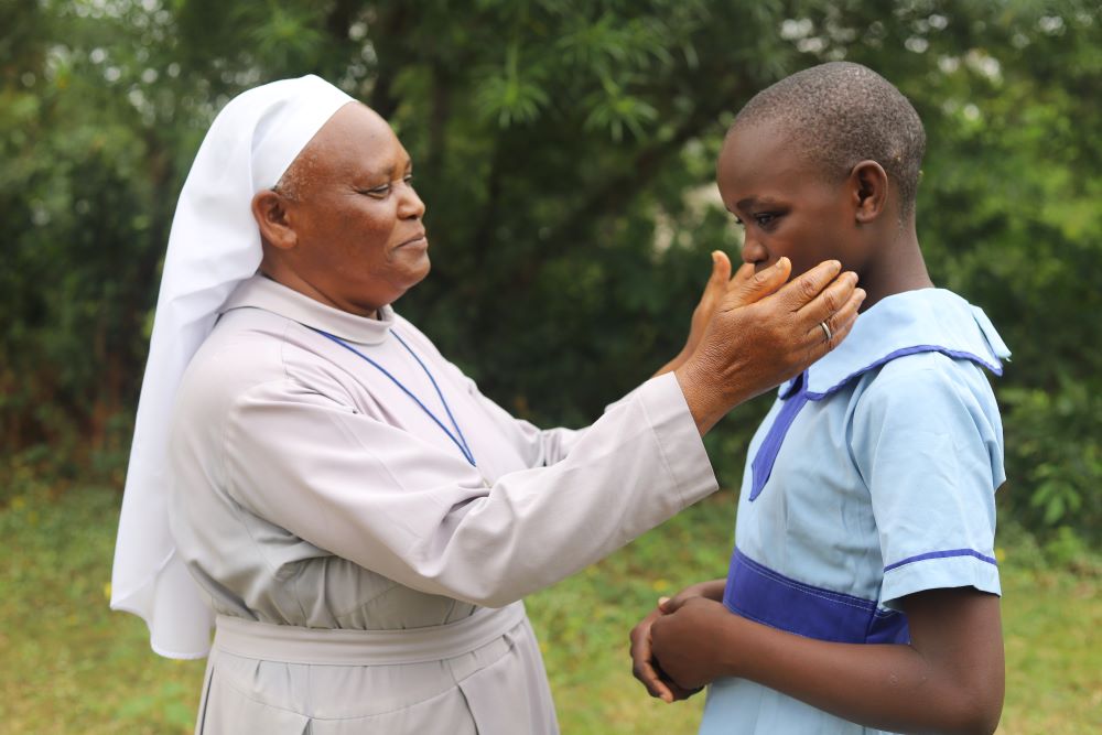 Sr. Bernadette Nthenya of the Sisters of Mary of Kakamega interacts with a girl she rescued from selling fish on the shores of Lake Victoria.