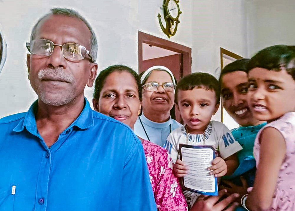 A Sacred Heart nun with one of the 50,000 families visited under the home mission faith renewal program of the Palai Diocese, southwestern India (Courtesy of Rosmin Cheruvil)