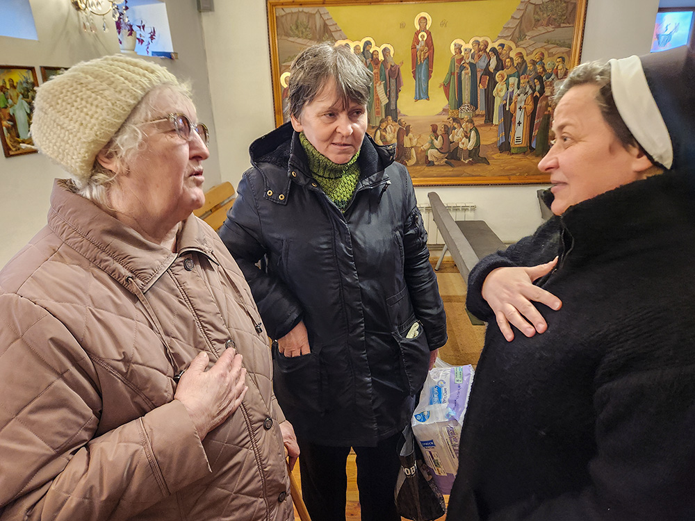 Basilian Sr. Lucia Murashko meets with two visitors at her convent, Petrova Yevdokia, 80, left, and Diakova Lubov, 58, center. Both women were displaced during Russia’s full-scale invasion of Ukraine and both now live in Zaporizhzhia, Ukraine. (GSR photo/Chris Herlinger)