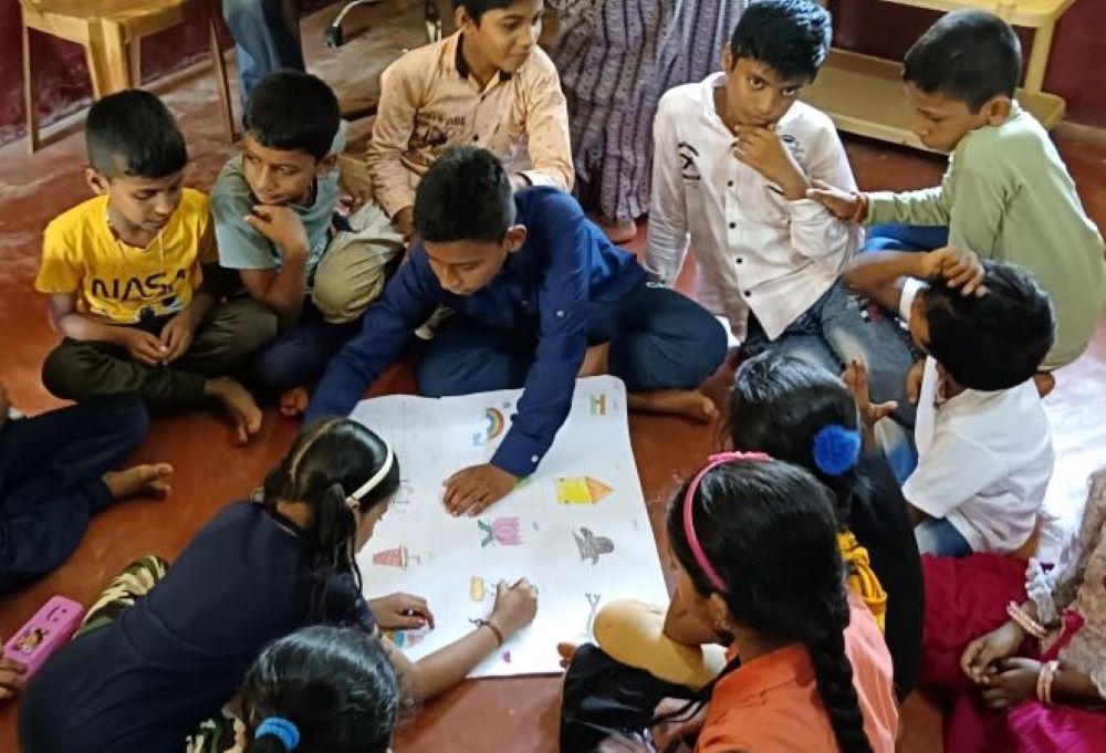 Children work on a group project during summer camp