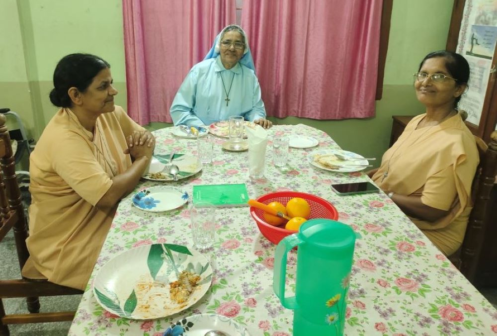 Two Maria Bambina nuns share a meal with Sr. Maria Goretti.