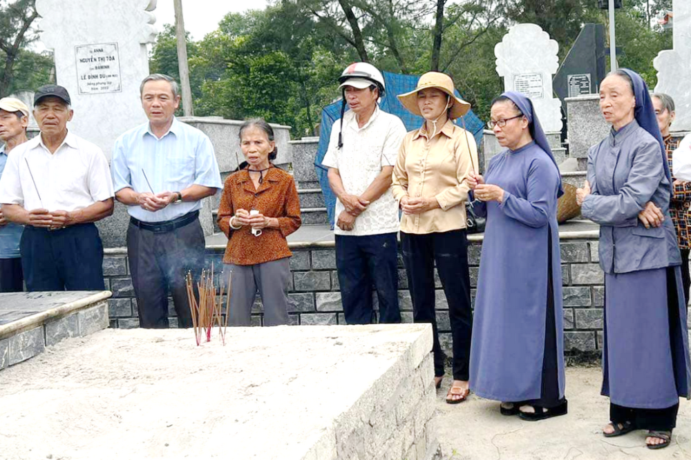 Group offers incense as they pray before an unattended grave. 