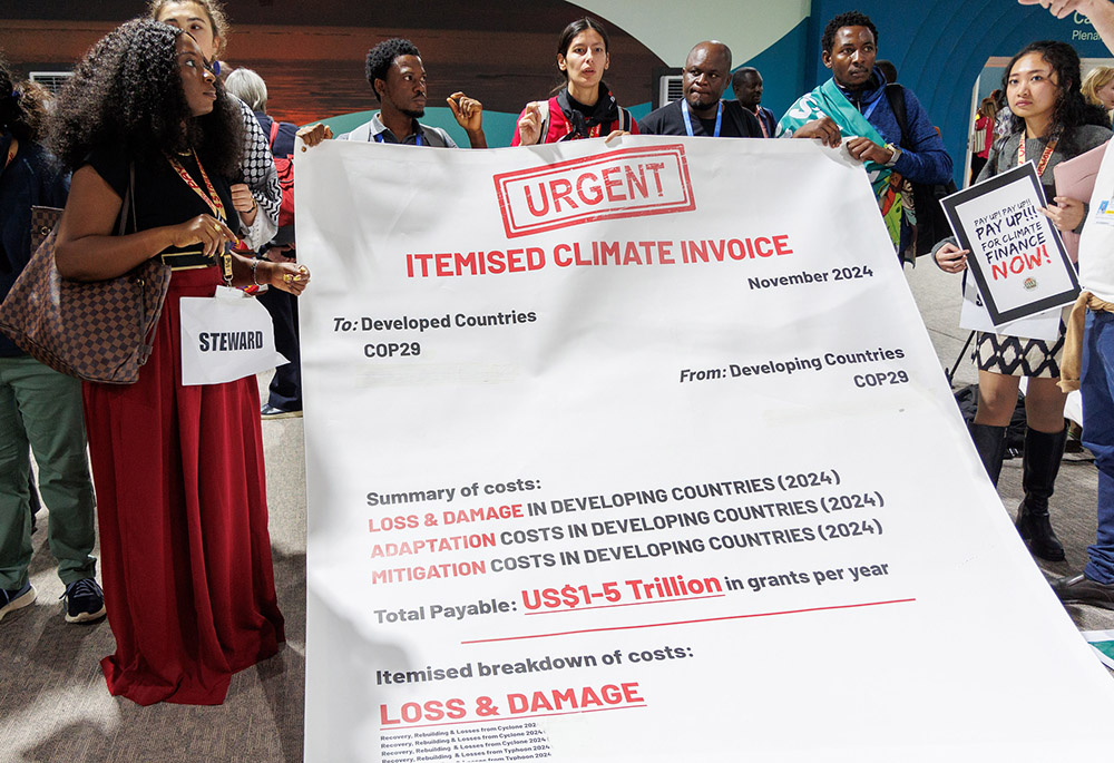 Climate activists demonstrate inside Baku Stadium at the United Nations climate change conference, COP29, on Nov. 16. A major focus is a new climate finance target, with developing nations calling on developed nations to deliver trillions of dollars in the next decade. (UN Climate Change/Habib Samadov)