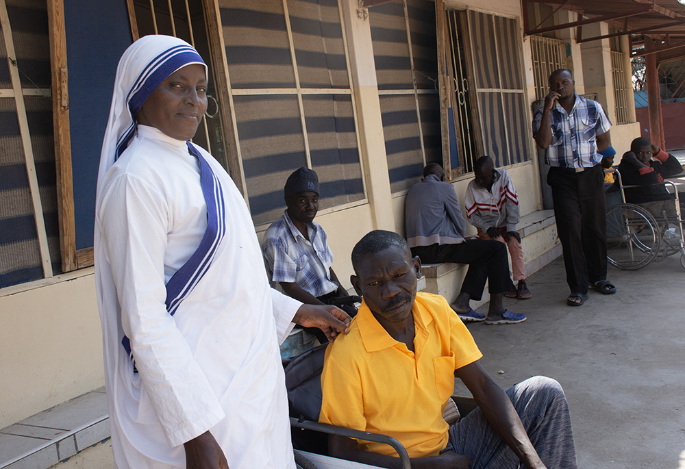 Sr. Mercy Kanyoro interacts with patients at the Mother Theresa Hospice. The hospice is a refuge for the sick and dying, located on the outskirts of Kabulonga, an exclusive suburb adjacent to Kalingalinga, a slum in Lusaka, Zambia. (Derrick Silimina)