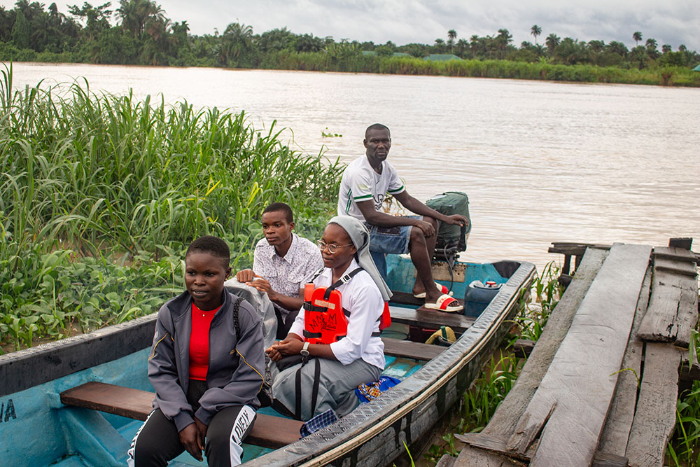 Medical Missionaries of Mary Sr. Janefrances Ihekuna and her team return to a local jetty after their weekly awareness campaign in Fou-Torugbene, a community located 30 minutes by boat from Torugbene, Nigeria, where Ihekuna is administrator for Mary Martin Primary Health Center. They also take health care services to other communities like BlouTamigbe, Isrealiozion, and Akwaware quarter once a month at a subsidized rate. (GSR photo/Valentine Benjamin)