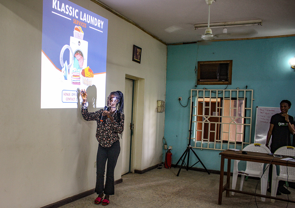 Blessing Udeh displays her Klassic Laundry ad banner design during her project presentation and defense in July. She was among the many students who joined the program in April when the free digital skill boot camp opened. (GSR photo/Valentine Benjamin)