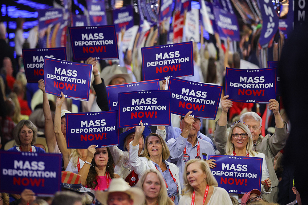 Delegates hold "Mass deportation now!" signs on Day 3 of the Republican National Convention at the Fiserv Forum in Milwaukee July 17, 2024. (OSV News photo/Reuters/Brian Snyder)