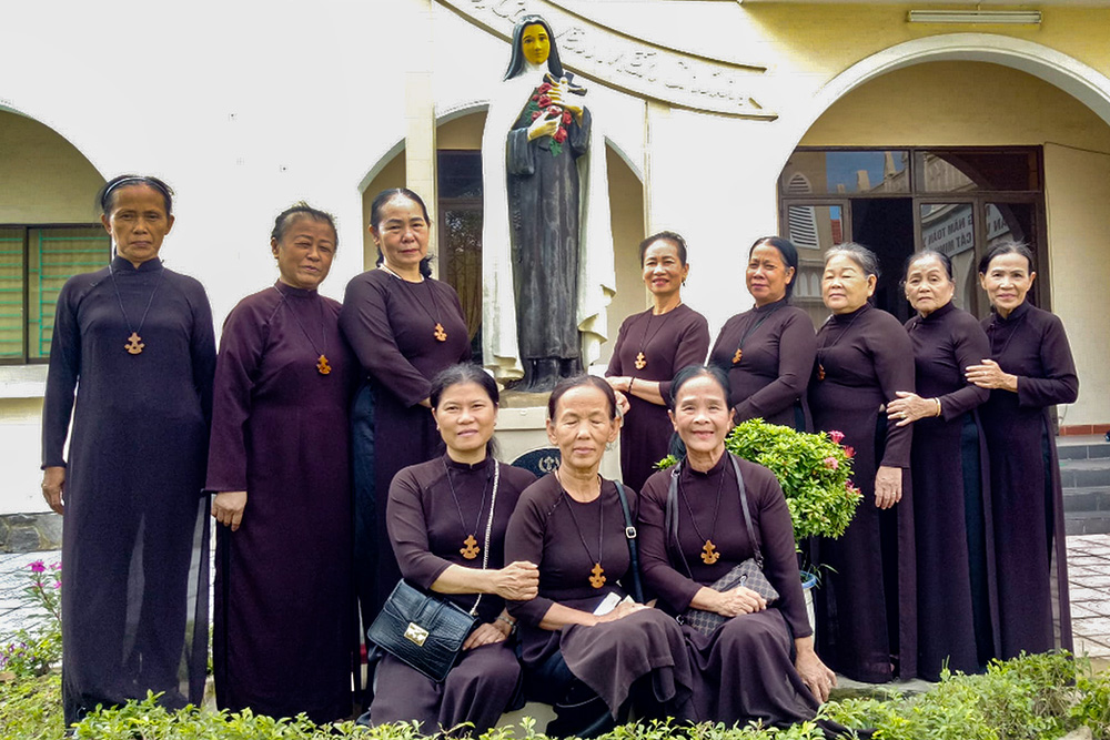 Carmelites Association members in their uniform pose for a picture after their monthly meeting at the Discalced Carmelites Convent on Aug. 18. (Joachim Pham)