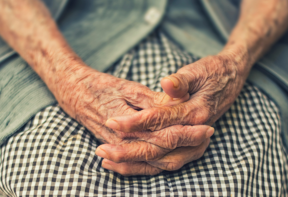 An elder adult's hands are displayed in this photo illustration. (Unsplash/Danie Franco)