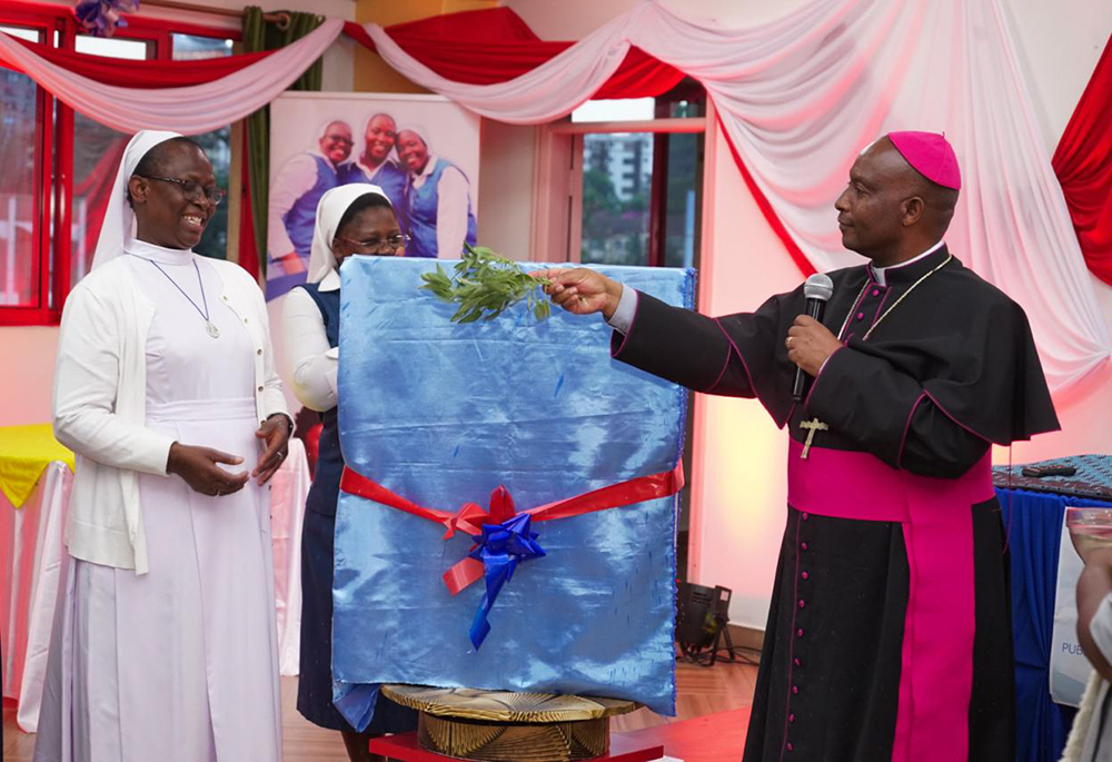 Sr. Agnes Lucy Lando and Bishop Wallace Ng'ang'a Gachihi of the Military Ordinariate of Kenya unveil the cover of her new book Moving Into Unreached Pastoral Frontiers: Making Visible the Impact of Catholic Sisters Serving in Non-Catholic Institutions on Oct. 30 at Paulines Communication Centre in Nairobi. (Courtesy of Association for Catholic Information in Africa and FIAT Communications and Consultancy Centre, Nairobi)