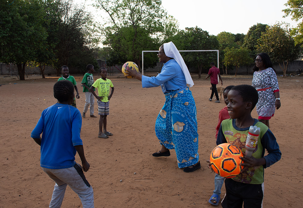 Sr. Catherine Mpolokoso, with senior staff members at Lubasi Home, joins some of the children to play some games at the facility in Livingstone, Zambia. Lubasi Home offers care to abandoned, neglected, vulnerable and orphaned children. They also reintegrate children into loving families through foster care and adoption. (Derrick Silimina)