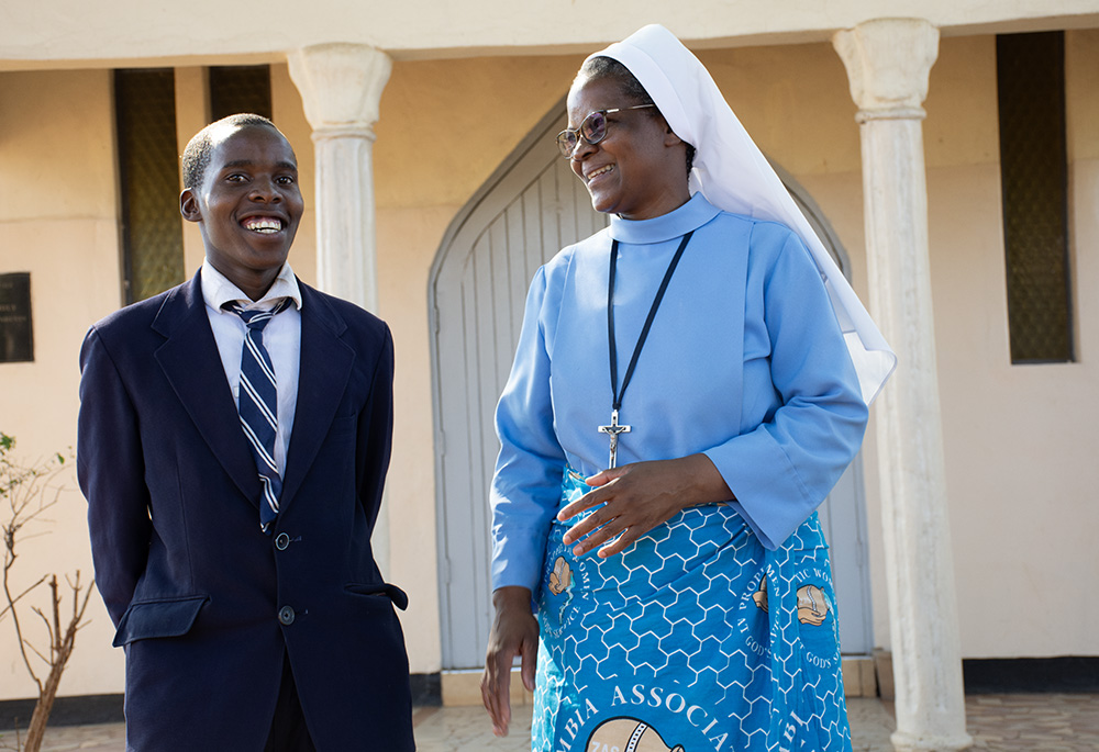 Timothy Siazanga shares a light moment with Sr. Catherine Mpolokoso of the Little Servants of Mary Immaculate at Lubasi Home in Livingstone. (Derrick Silimina)