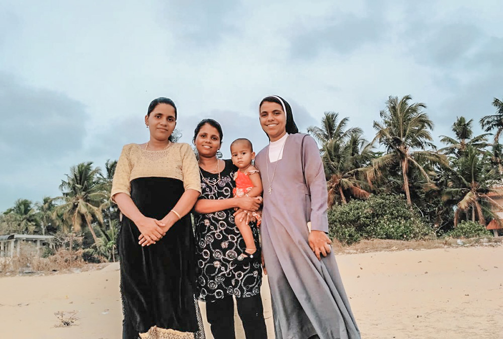 Augustinian Sr. Nidhisha Janson with her sisters at their beachside house. The siblings' parents are buried at the Church Cemetery, which is also facing eviction in Munambam, Kerala, India. (Courtesy of Nidhisha Janson)