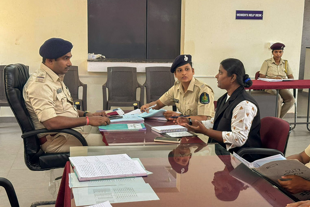 Canossian Sr. Grasy Rodrigues discusses a rape case with police personnel at Mandarem, Goa, western India. (Courtesy of Grasy Rodrigues)