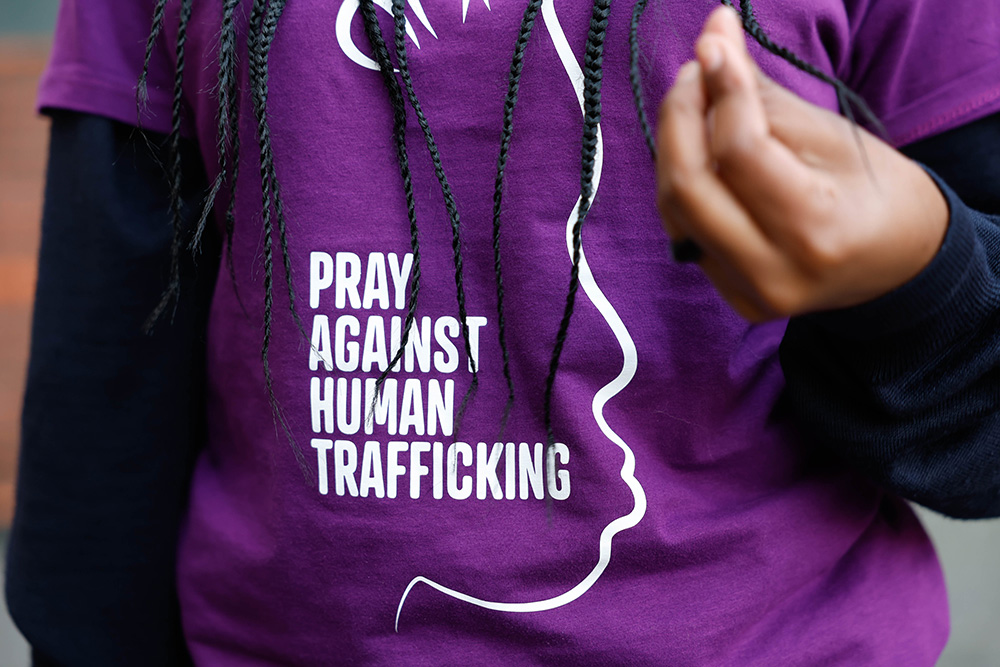 Mary Mugo from Nairobi, Kenya, wears a T-shirt that reads "Pray Against Human Trafficking" as she joins other young people in Rome's central Santa Maria in Trastevere Square Feb. 6, 2024, to raise awareness about human trafficking. (CNS/Lola Gomez)