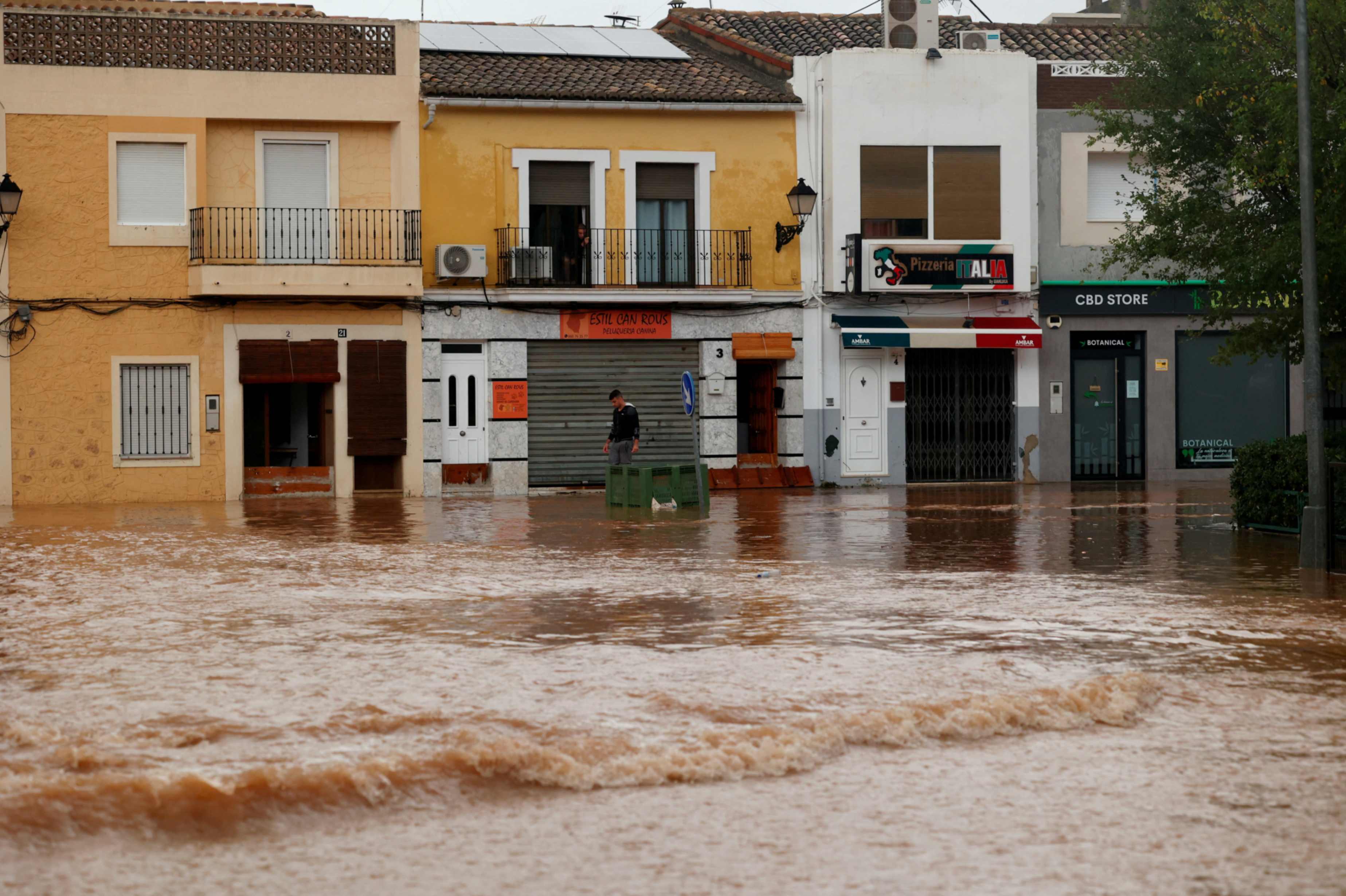 A person walks through a flooded street on Oct. 30, 2024, in Llombai, in Valencia, Spain, after the Spanish meteorological agency put the region on maximum red alert for extreme rainfall. (OSV News/Reuters/Eva Máñez)