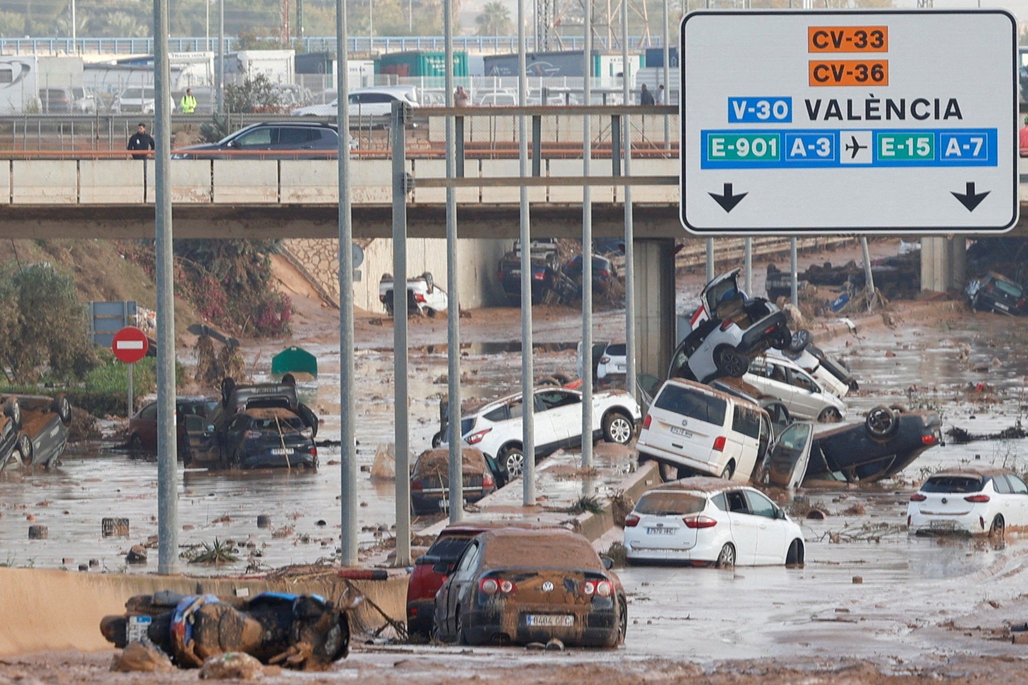 Cars were swept away by the force of water on Oct. 31, 2024, on a road on the outskirts of Valencia, Spain, where torrential rains caused flooding. (OSV/Reuters/Eva Máñez)