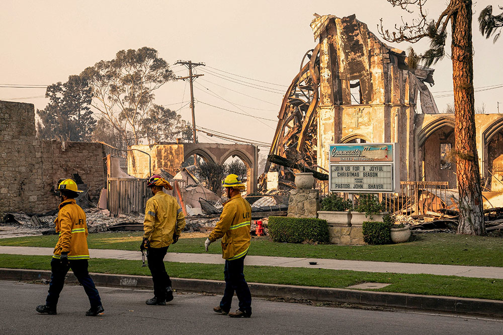 Firefighters walk near a destroyed Methodist church Jan. 10, 2025, following the Palisades Fire in Los Angeles. (OSV News/Reuters//David Ryder)