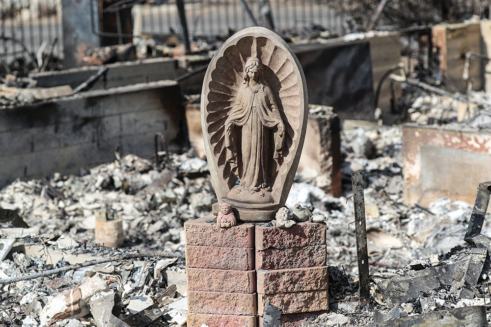 A statue of Mary rests nearly untouched in the rubble of a destroyed home in Altadena, Calif., Jan. 17, 2025, in the aftermath of the Eaton Fire, which began Jan. 7. (OSV News/Bob Roller)