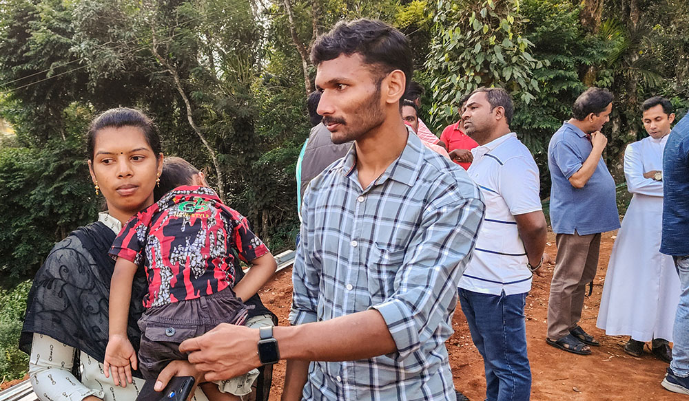 Lijo Thekkilakattil with his wife and son during the handing of keys to his new temporary house at Chooralmala in Wayanad, Kerala, southwestern India (Thomas Scaria)