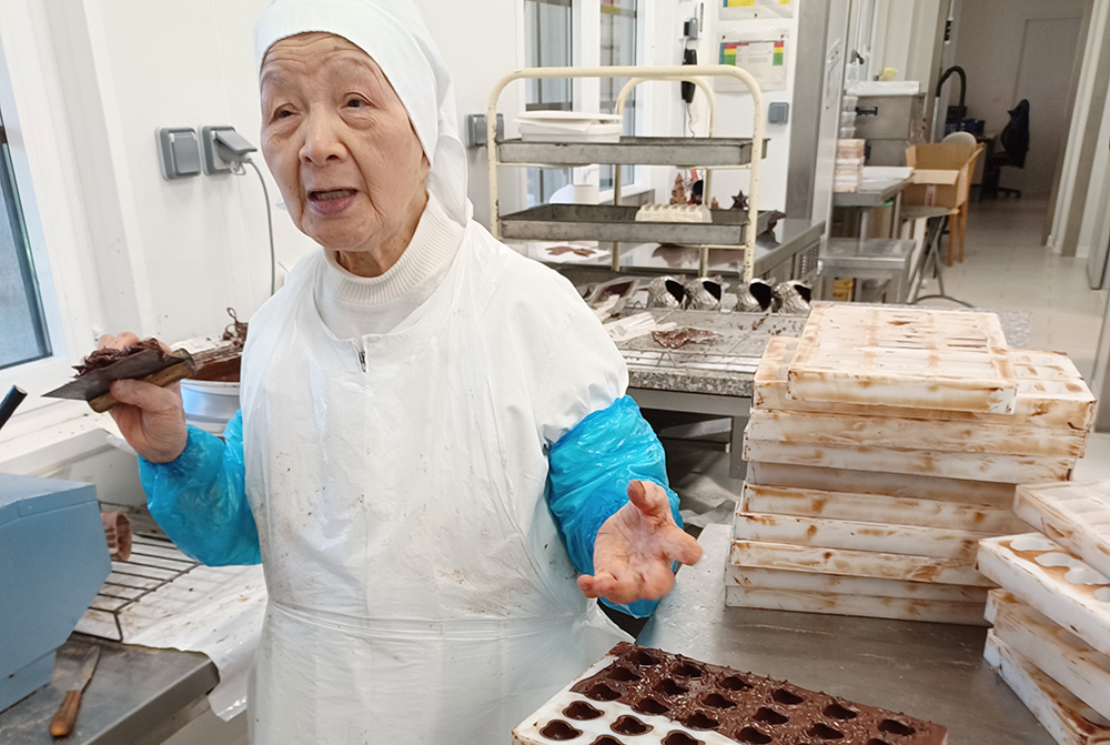 Sister Emmanuel, in her 80s, loves her job in the chocolate factory of the Cistercian sisters at Notre Dame de la Paix. (Elisabeth Auvillain)