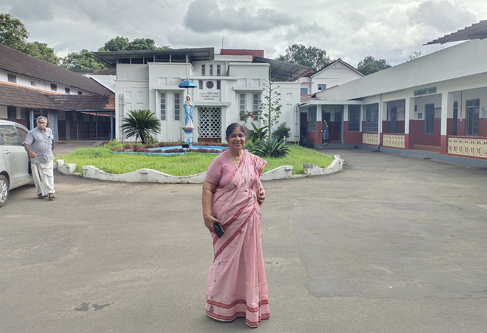 Medical Mission Sr. Joan Chunkapura, a psychologist who works among people with alcohol and drug dependence, is pictured in front of their only remaining hospital, Immaculate Heart of Mary Hospital at Bharananganam in the southwestern Indian state of Kerala. (Thomas Scaria)