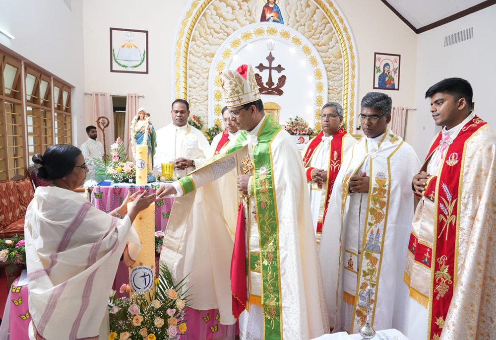 Changanacherry Archbishop-designate Thomas Tharayil of the Eastern Catholic Syro-Malabar Church lights a candle with Sr. Lilly Joseph, provincial, to mark the inauguration of the centenary celebrations of the Medical Mission Sisters on Sept. 28, 2024, in Changanacherry, Kerala, southwestern India. (Courtesy of Sr. Lilly Joseph)