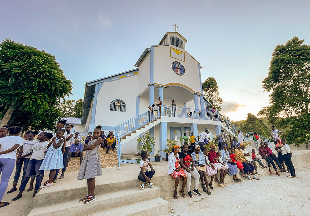 Parishioners of Our Lady of the Assumption Parish in Meyer Grande, Haiti, wait outside their newly built church for services to begin. Parishioners built the structure, with support from members of St. Margaret Mary Catholic Church in Winter Park, Fla. (Courtesy of St. Margaret Mary Church)