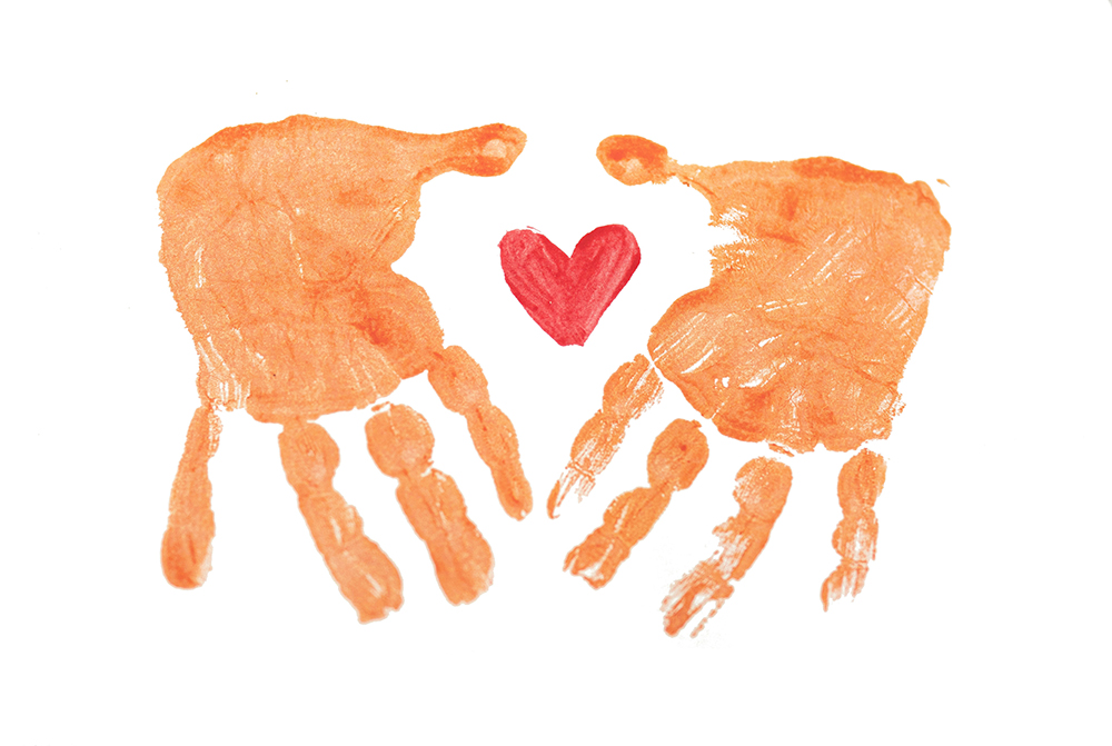 Two painted hands surrounding a heart (Unsplash/Rod Long)