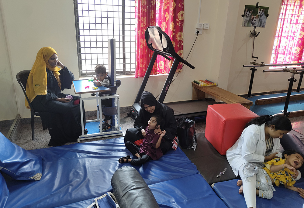 Fathima Muhammed is pictured waiting for her 3-year-old son's turn for daily physiotherapy at Navajeevana in Bedrampalla, Kasaragod District, Kerala, southwestern India. (George Kommattam) 