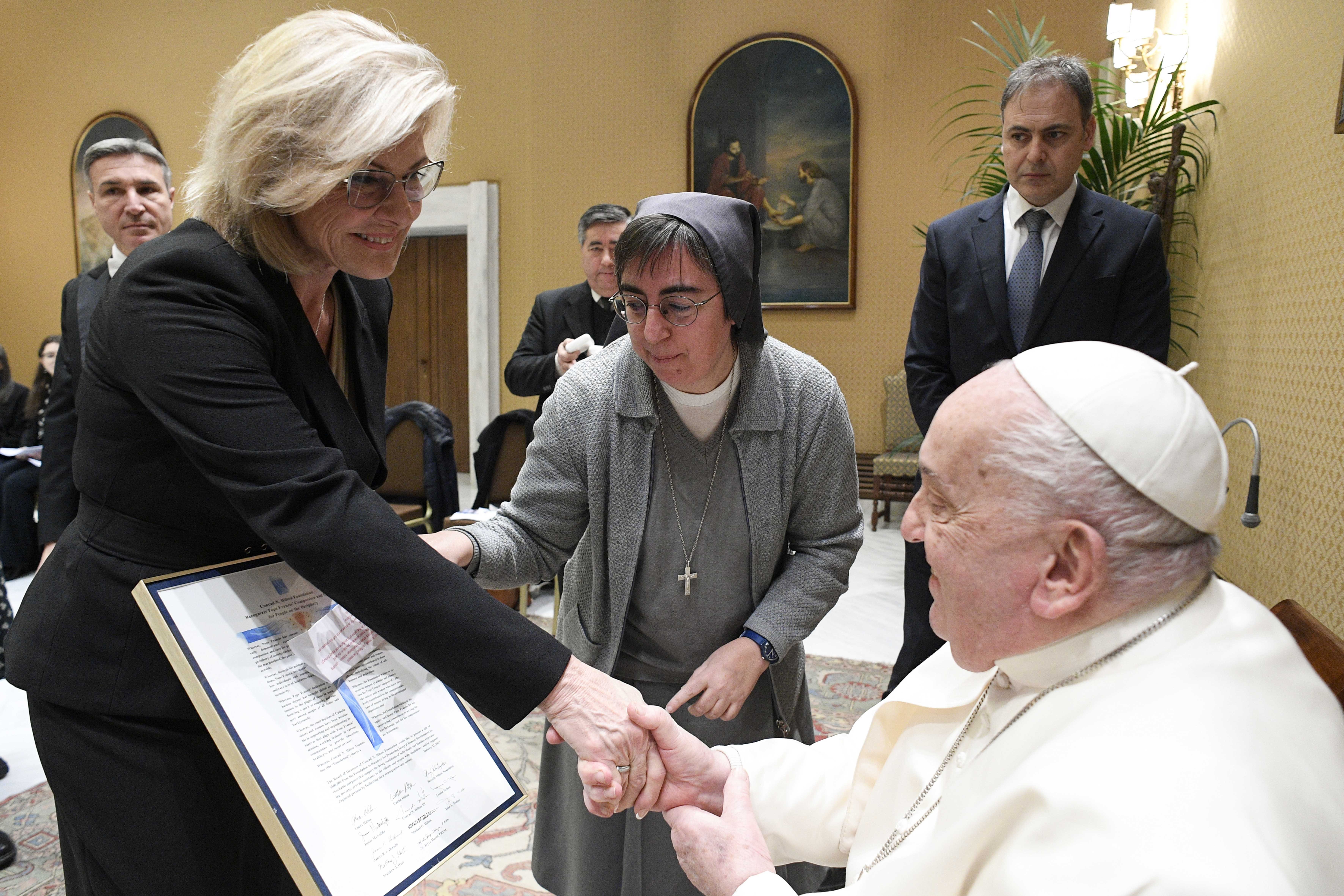 Pope Francis shakes hands with Linda Hilton during an audience with the foundation at the Vatican on Jan. 22, 2025. Standing with her is Salesian Sr. Alessandra Smerilli, secretary of the Dicastery for Promoting Integral Human Development.