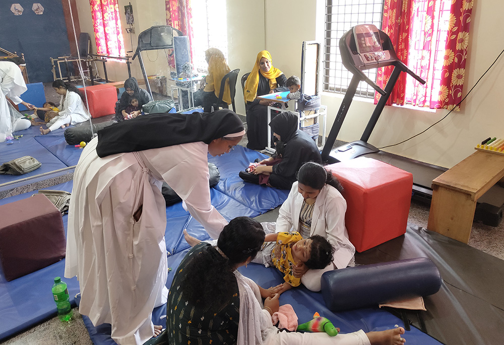 Franciscan Clarist Sr. Mareena Mathew is pictured with a therapist, parent Keerthi Ramakrishnan and Ramakrishnan's son Kashi at Navajeevana Endosulfan Special School, Bedrampalla, Kasaragod District, Kerala, southwestern India. (George Kommattam)