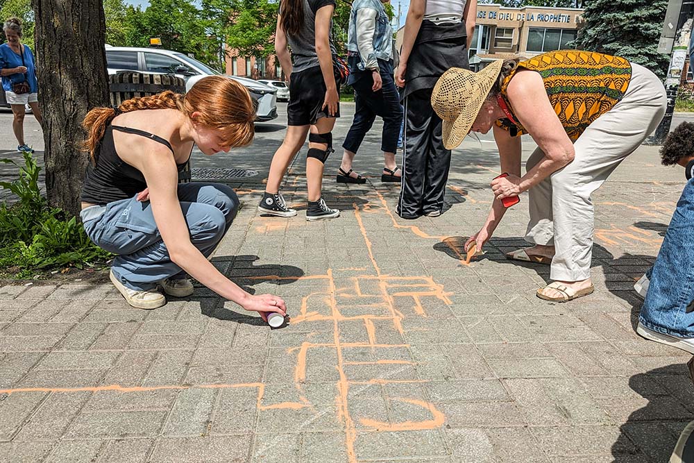 Talitha Kum ambassadors in Montreal take part in the activity "Agissons enSable," using colourful sand as a symbol of the vulnerable population at risk of falling between the cracks (Courtesy of IsaBelle Couillard)