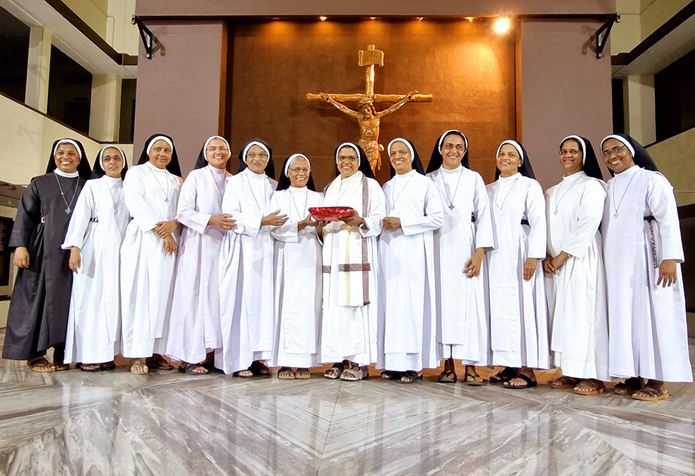 Congregation of the Mother of Carmel Sr. Noel Rose (with shawl and gift), is pictured with her provincial superior Sr. Maria Anto (right of Rose) and her community members at the reception held at the Mother Carmel Provincial House in the southwestern Indian state of Kerala. (Courtesy of Sr. Noel Rose)