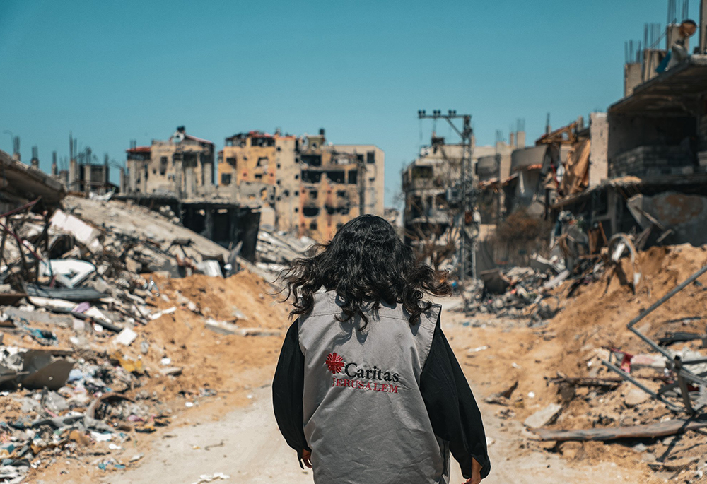 A Caritas worker walks through destroyed buildings in Gaza City on March 16, 2024. (OSV News/Courtesy of Caritas Poland)