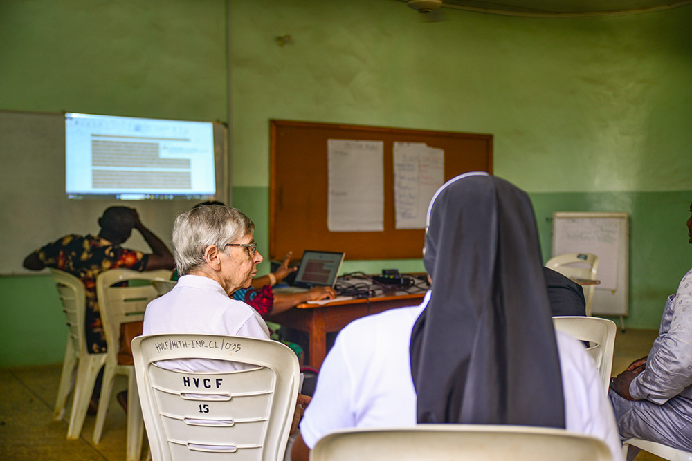 Sr. Rita Schwarzenberger listens during a staff meeting of the Hope for the Village Child Foundation. (Patrick Egwu)