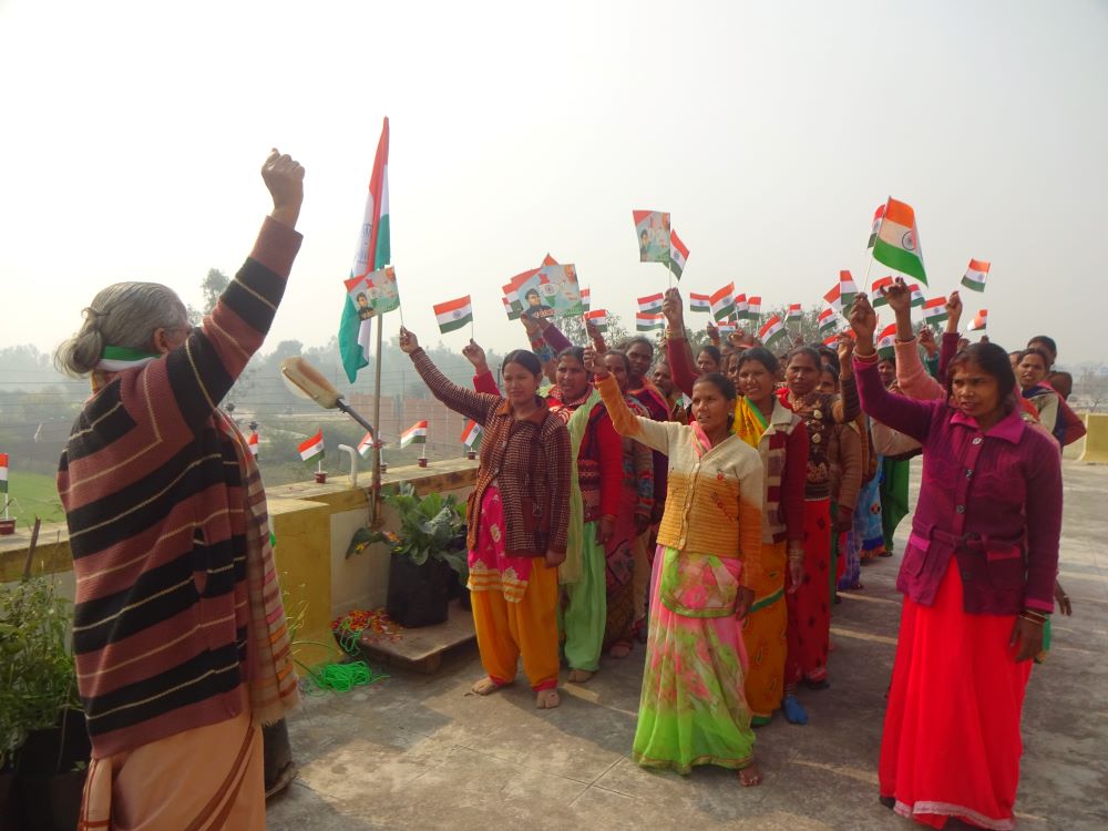 Women raise their arms in celebration.