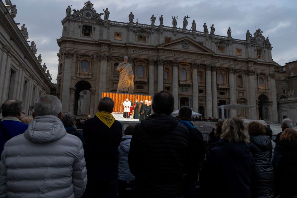 Screen in St. Peter's Square shows clergy saying rosary.