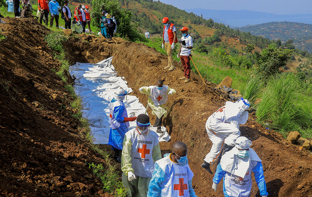 Congolese Red Cross members bury body bags in a mass grave at Musigoko cemetery in Bukavu, Congo, Feb. 20, 2025. The bags contained the remains of victims killed in recent clashes between M23 rebels and the armed forces of the Democratic Republic of the Congo. (OSV News/Reuters/Victoire Mukenge)